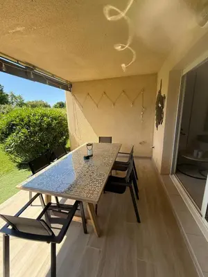 a table and chairs in a room with a patio at Villa désirée à Santa Maria Poggio in Santa-Maria-Poggio