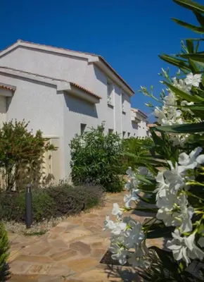 a building with white flowers in front of it at Casabella 3 chambres in Cervione