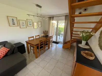 a living room with a couch and a table at Casabella 3 chambres in Cervione