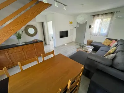 a living room with a table and a couch at Casabella 3 chambres in Cervione
