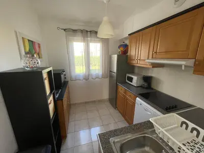 a kitchen with a black refrigerator and a sink at Casabella 3 chambres in Cervione