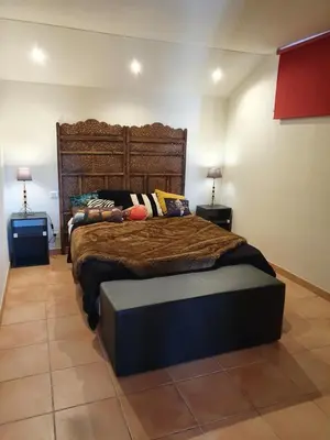 a bedroom with a large bed and two lamps at Appartement Appietto in Appietto