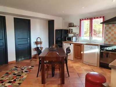 a kitchen with a table and a stove top oven at Appartement Appietto in Appietto