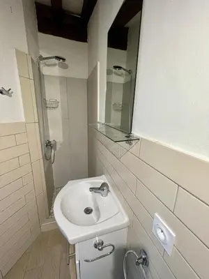 a white bathroom with a sink and a shower at Piana in Porto-Vecchio