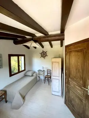 a bedroom with a bed and a table at Piana in Porto-Vecchio