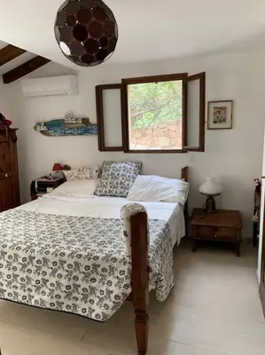 a bedroom with a bed and a window at Piana in Porto-Vecchio