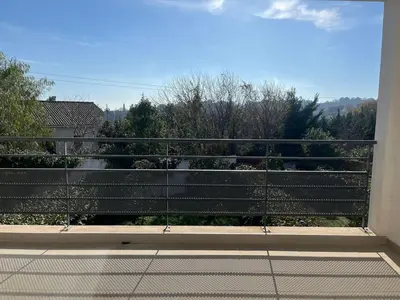 a balcony with a view of a garden at Appartement proche de la plage in Santa-Lucia-di-Moriani