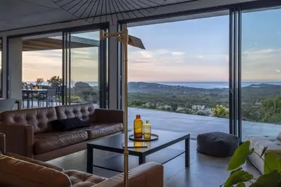 a living room with a couch and a table at family villa, beautiful open sea view & scrubland in Conca