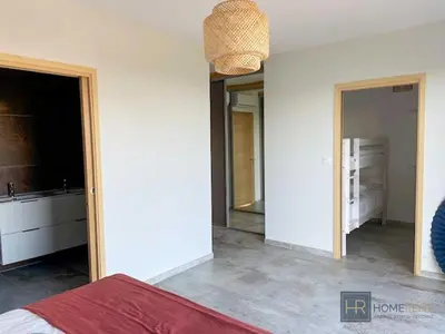 a bedroom with a bed and a bathroom with a mirror at family villa, beautiful open sea view & scrubland in Conca