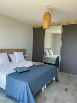 a bedroom with a bed with a blue blanket at family villa, beautiful open sea view & scrubland in Conca