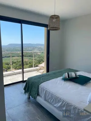 a bedroom with a bed and a large window at family villa, beautiful open sea view & scrubland in Conca