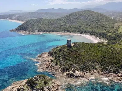 an island with a lighthouse in the middle of the ocean at family villa, beautiful open sea view & scrubland in Conca