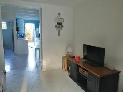 a living room with a flat screen tv on a table at Maison bord de mer climatisée en Corse in Poggio-Mezzana