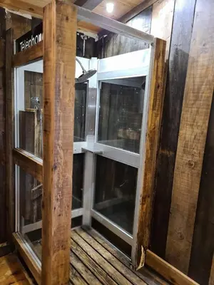 an open glass door in a room with wooden floors at Cabane avec Piscine in Sartène