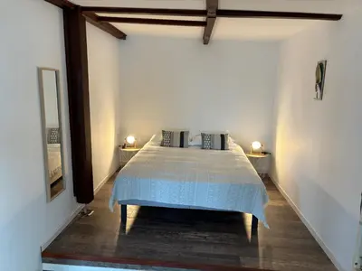 a bedroom with a bed in a room with two lamps at CHALET de la plage in Porticcio