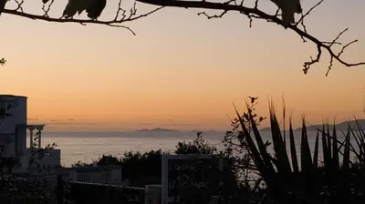 a view of the ocean at sunset at CHALET de la plage in Porticcio
