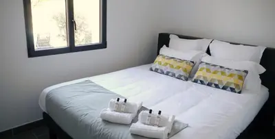 a large white bed with two pillows on it at Les Terrasses Du Grand Large in Porto Pollo