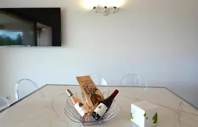a basket of wine bottles on a glass table at Les Terrasses Du Grand Large in Porto Pollo