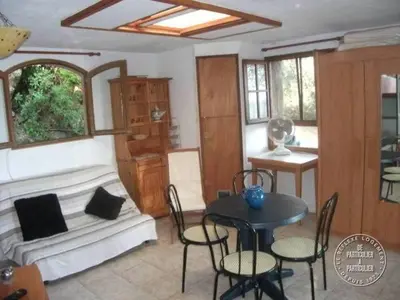 a living room with a couch and a table with chairs at Villa Pierre Vergerie in Cargèse
