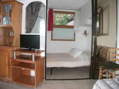 a room with a bedroom with a bed and a mirror at Villa Pierre Vergerie in Cargèse