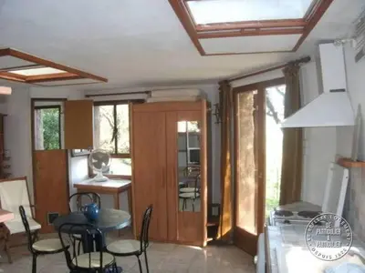 a kitchen and dining room with a table and chairs at Villa Pierre Vergerie in Cargèse