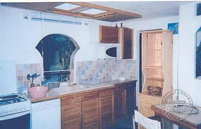 a kitchen with a sink and a stove at Villa Pierre Vergerie in Cargèse