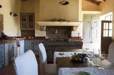 a kitchen with a table with a bowl of fruit on it at Le Hameau de Saparale in Sartène