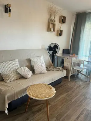 two lawn chairs sitting outside of a house at Appartement au bord de mer in Ghisonaccia