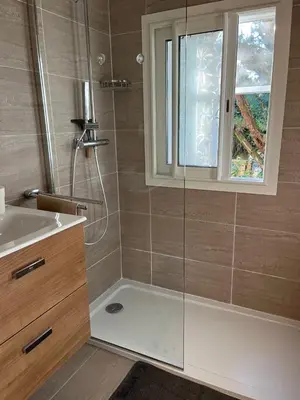 a bathroom with a shower and a sink and a window at Villa Nausicaa in Pietrosella