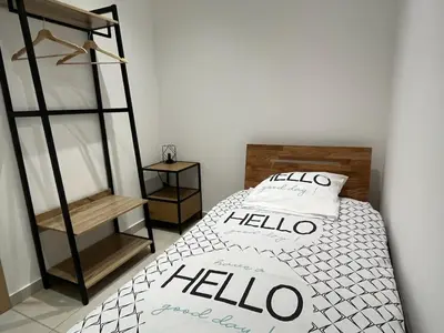 a bedroom with a bed with a hello pillow at Bas de villa contemporaine avec vue dégagée in Alata