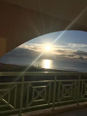 a view of the sunset from the balcony of a condo at Appart bord de mer avec piscine in San-Nicolao