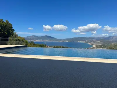 a swimming pool with a view of the water at Villa de Luxe avec Piscine à débordement chauffée à Porticcio in Porticcio