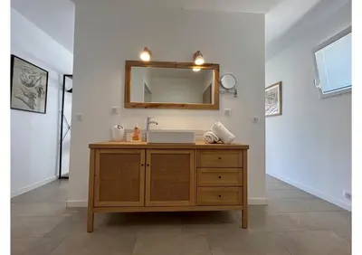 a bathroom with a sink and a mirror at Patios di pruno Suite MELO in Figari