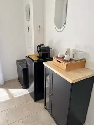 a kitchen with two black counters and a sink at Patios di pruno Suite MELO in Figari