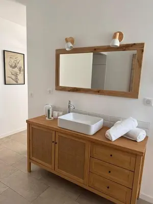 a bathroom with a sink and a mirror at Patios di pruno Suite MELO in Figari