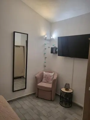 a waiting room with a chair and a mirror at Porto Vecchio - Résidence RIVIERA- Villa Lecci in Lecci