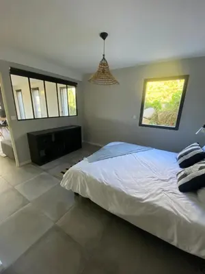 a bedroom with a large bed and a window at Porto-Vecchio - Lecci Lodge in Lecci