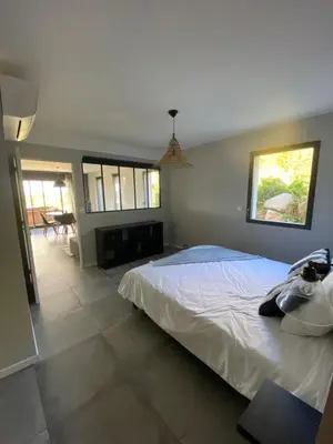 a bedroom with a large bed and a fireplace at Porto-Vecchio - Lecci Lodge in Lecci