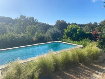 a swimming pool in the middle of a garden at Porto-Vecchio - Lecci Lodge in Lecci