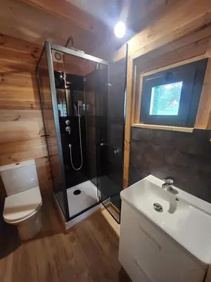 a bathroom with a shower and a toilet and a sink at Crique privée in Conca