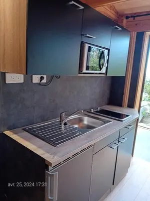 a kitchen with a sink and a counter top at Crique privée in Conca