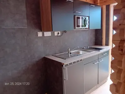 a kitchen with a sink and a counter top at Crique privée in Conca