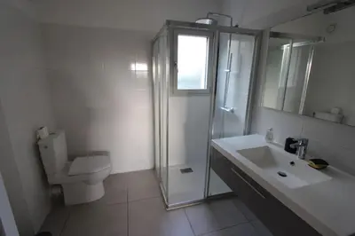 a bathroom with a shower and a toilet and a sink at T2 centre-ville de Porto-Vecchio in Porto-Vecchio