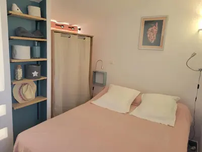 a small bed in a white room with a window at Porto Vecchio - Résidence RIVIERA- Villa Bonifacio in Lecci