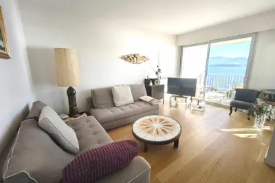a living room with a couch and a table at Beautiful T4 apt with a view of the Gulf d'Ajaccio in Ajaccio