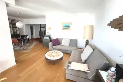 a living room with a couch and a table at Beautiful T4 apt with a view of the Gulf d'Ajaccio in Ajaccio