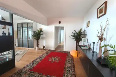a living room with a red rug on the floor at Beautiful T4 apt with a view of the Gulf d'Ajaccio in Ajaccio