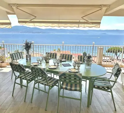 a table and chairs with a view of the ocean at Beautiful T4 apt with a view of the Gulf d'Ajaccio in Ajaccio