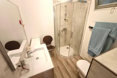 a bathroom with a shower and a toilet and a sink at Beautiful T4 apt with a view of the Gulf d'Ajaccio in Ajaccio