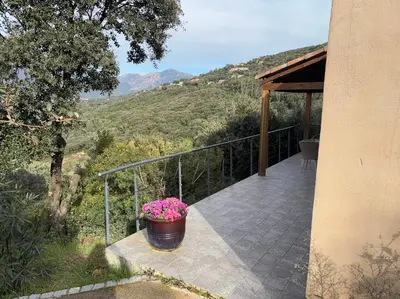 a balcony of a house with a pot of flowers at Casa Lisandru- Mini-Villa proche des plages in Viggianello